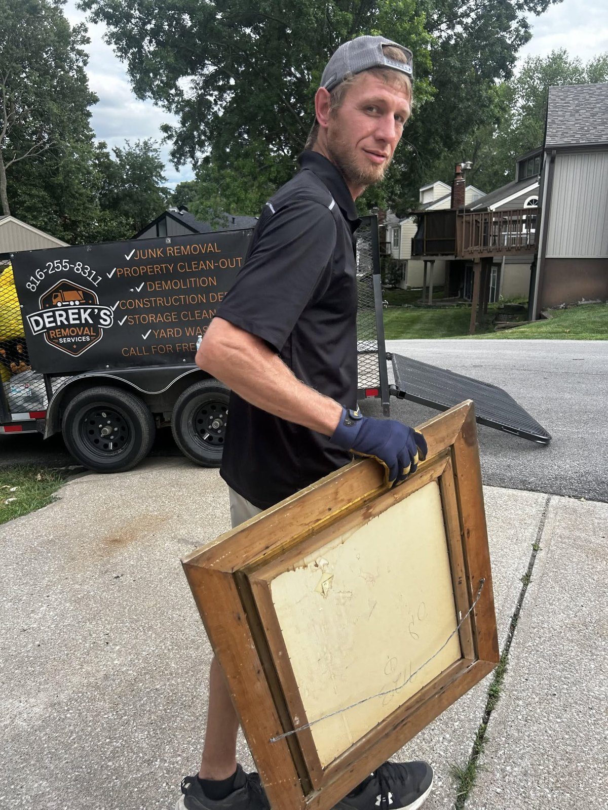 Derek carrying a framed item during a removal job