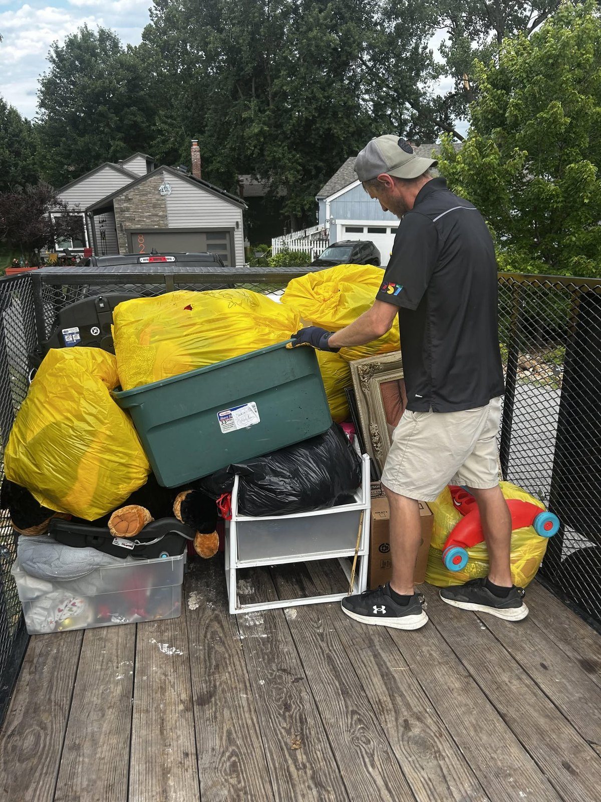 Derek loading household items into a removal trailer